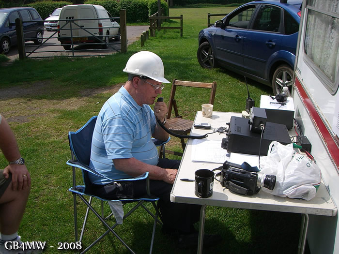 Fred G3SVK running the VHF station. Hard hat because of the strong sun, the antenna was safe, honest!
