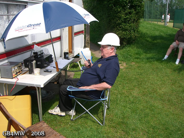 Bill G0BOF running the VHF station. Hard hat because of the strong sun, the antenna was safe, honest!

